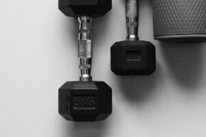 Two Dumbbells and exercise mattress on the floor - Top view